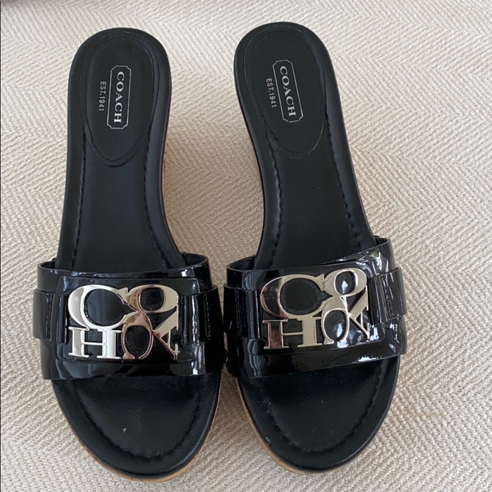 Black patent leather cork coach wedges.